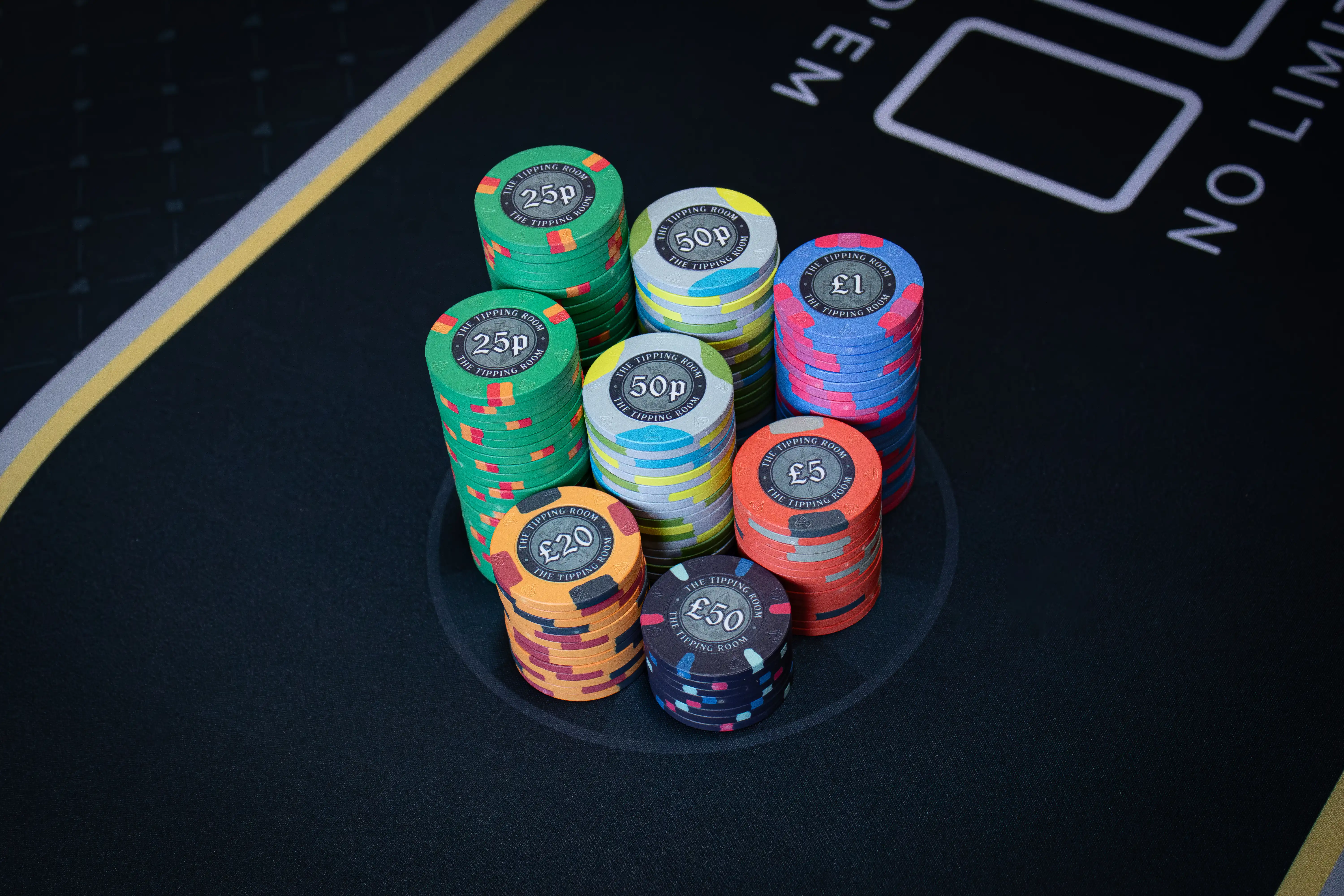 Selection of The Tipping Room custom ceramic poker chips showing medieval greyscale artwork across multiple denominations